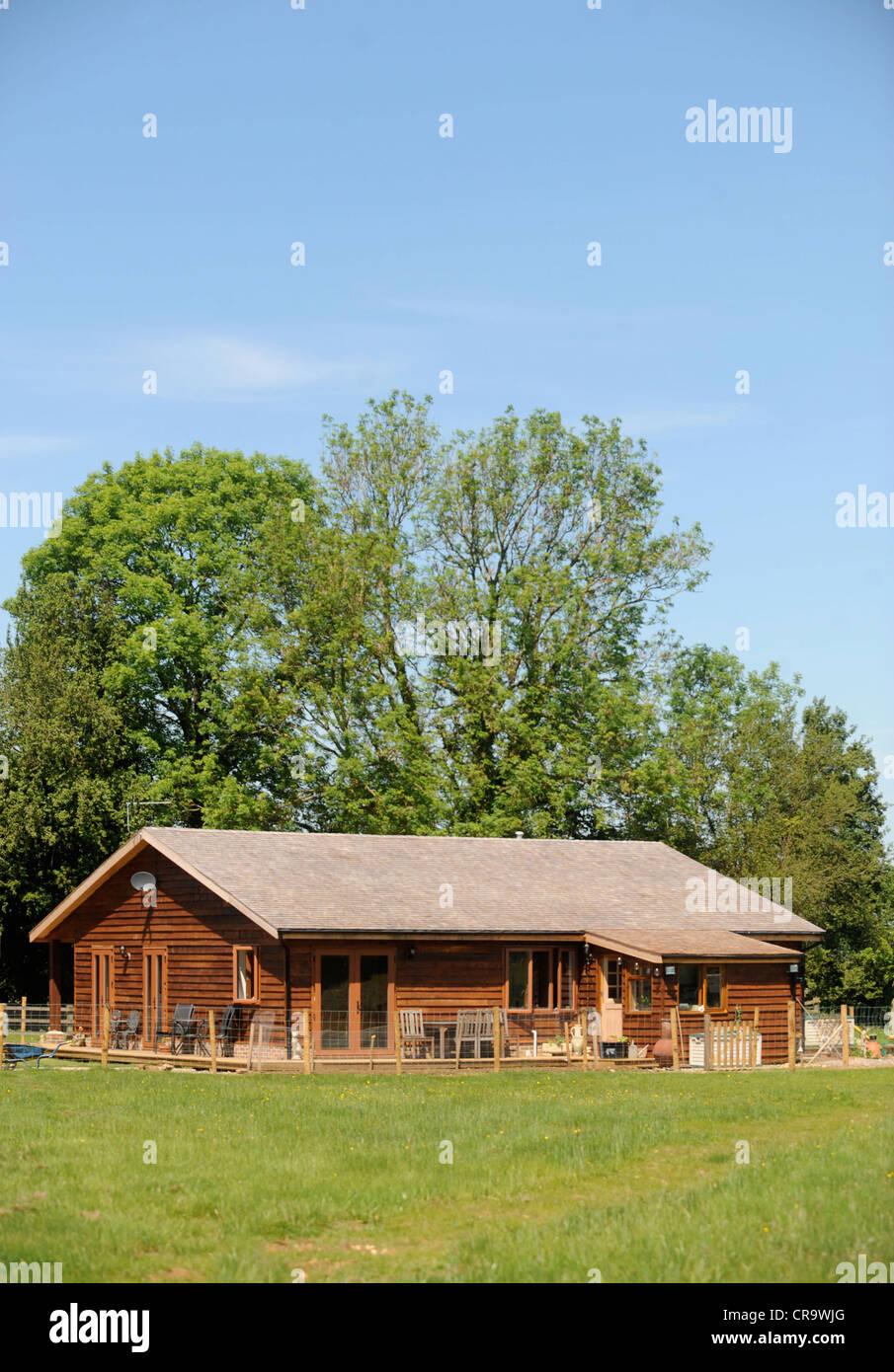 A log cabin or wooden chalet home - a style of construction often used due to planning regulations UK Stock Photo