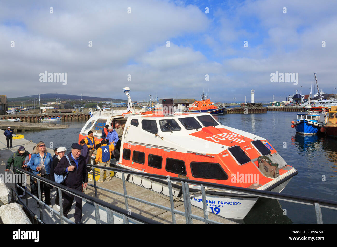 American tourists disembarking Caribbean Princess cruise ship landing craft arriving in Kirkwall harbour visiting Mainland Orkney Stock Photo