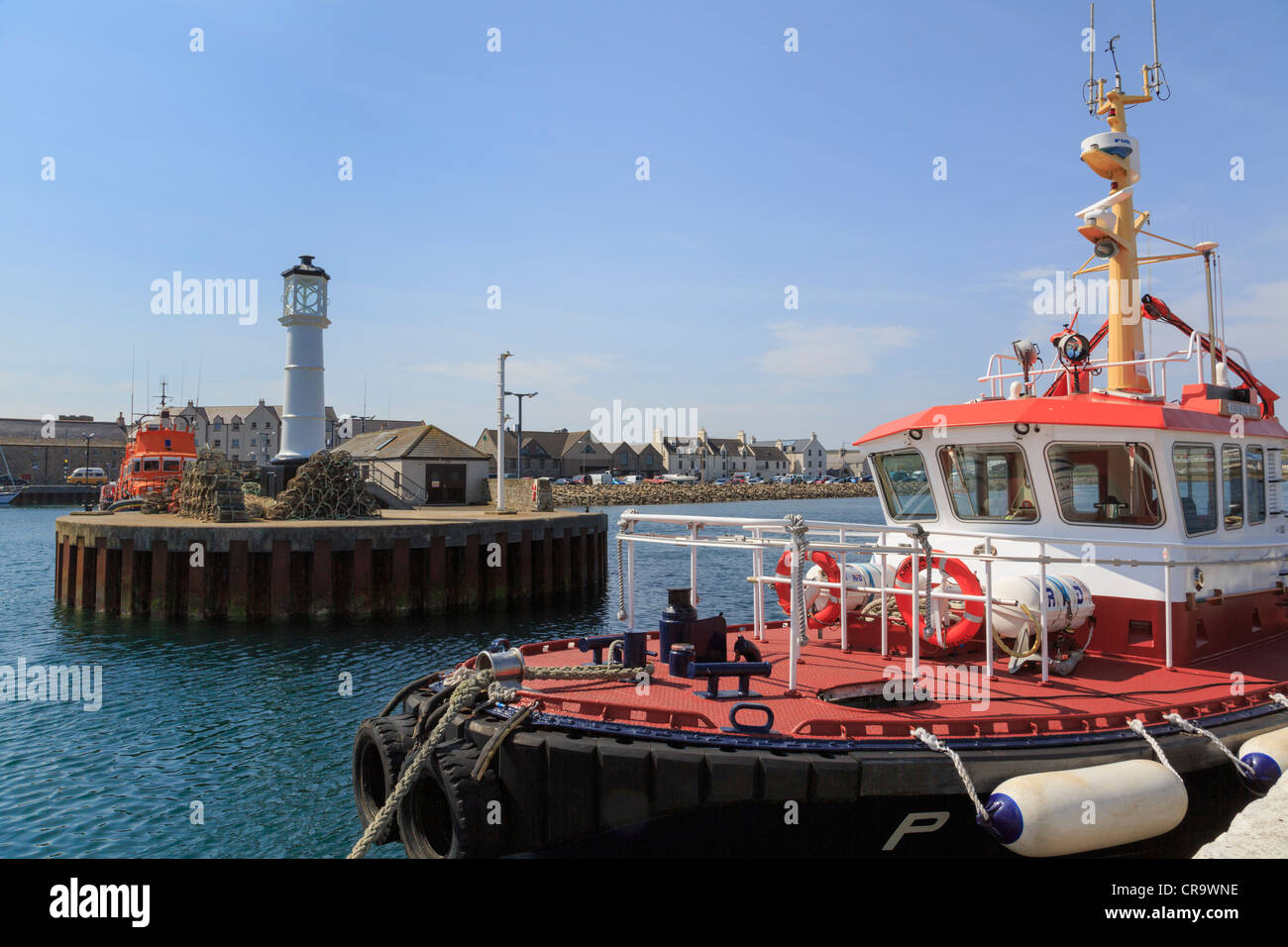 Kirkwall Bay pilot vessel and lighthouse at the harbour entrance in Kirkwall, Orkney Islands, Scotland, UK. Stock Photo