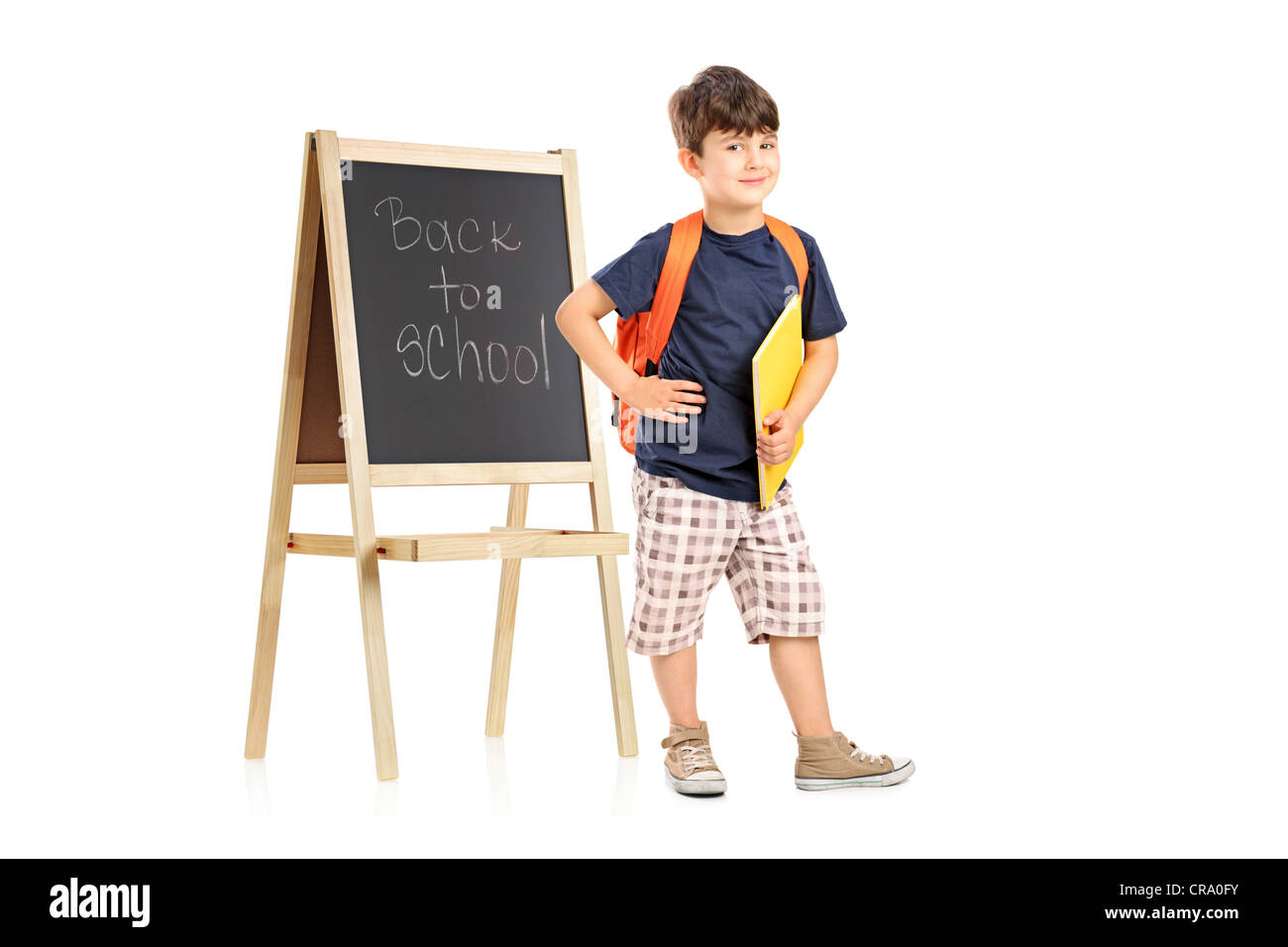 Full length portrait of a school boy with backpack posing next to a ...