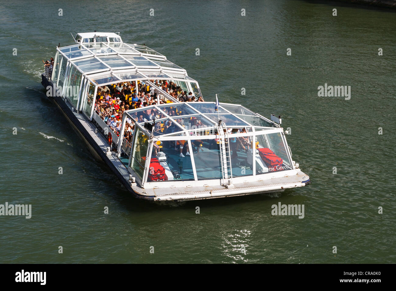 People on a boat tour on the Seine River - Paris, France Stock Photo