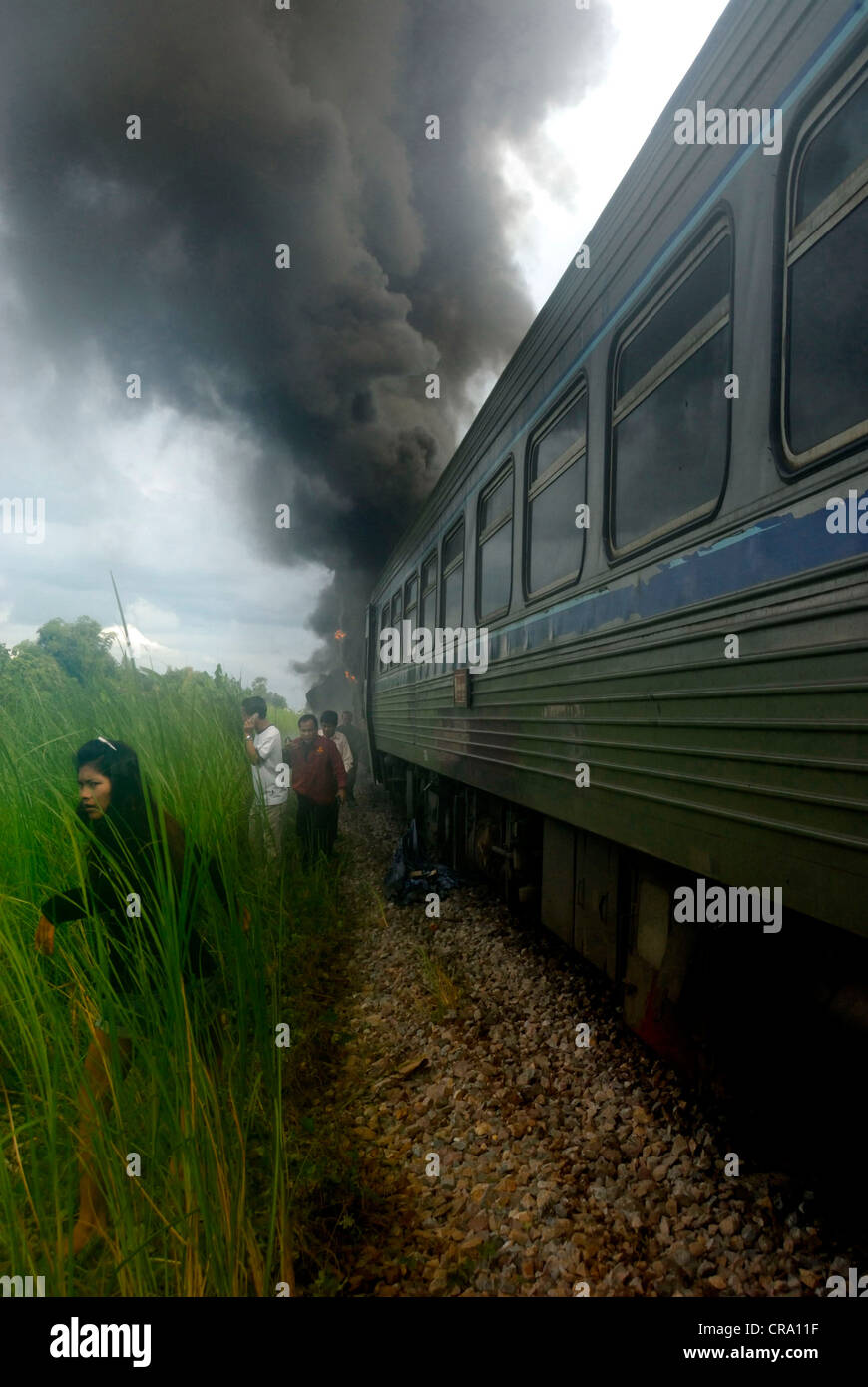 Passengers running from the burning train minutes after it crashed in Phitsanulok on 14/06/2011 in Phitsanulok Thailand Stock Photo