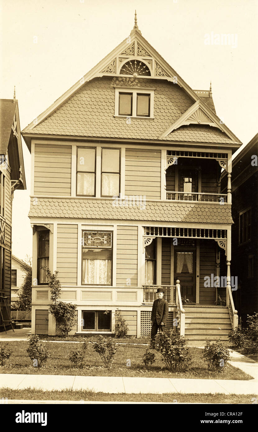 Young Man in front of Victorian Town Residence Stock Photo