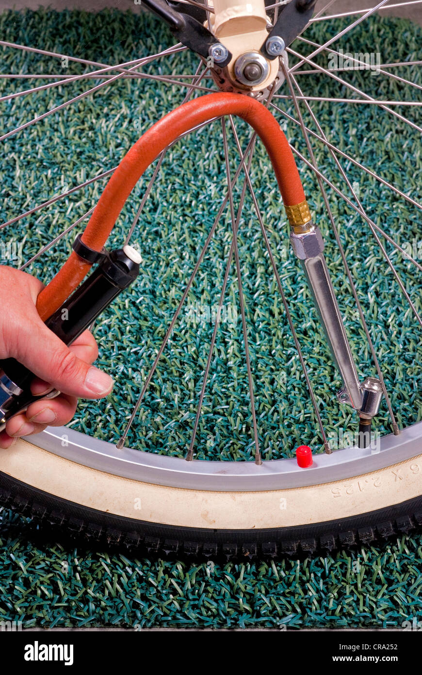 Compressed air is used to fill this bike tire Stock Photo
