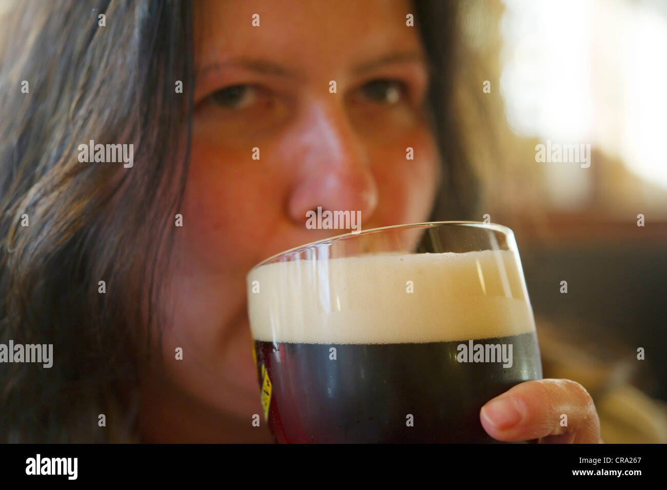 Woman drinking beer from a glass Stock Photo Alamy