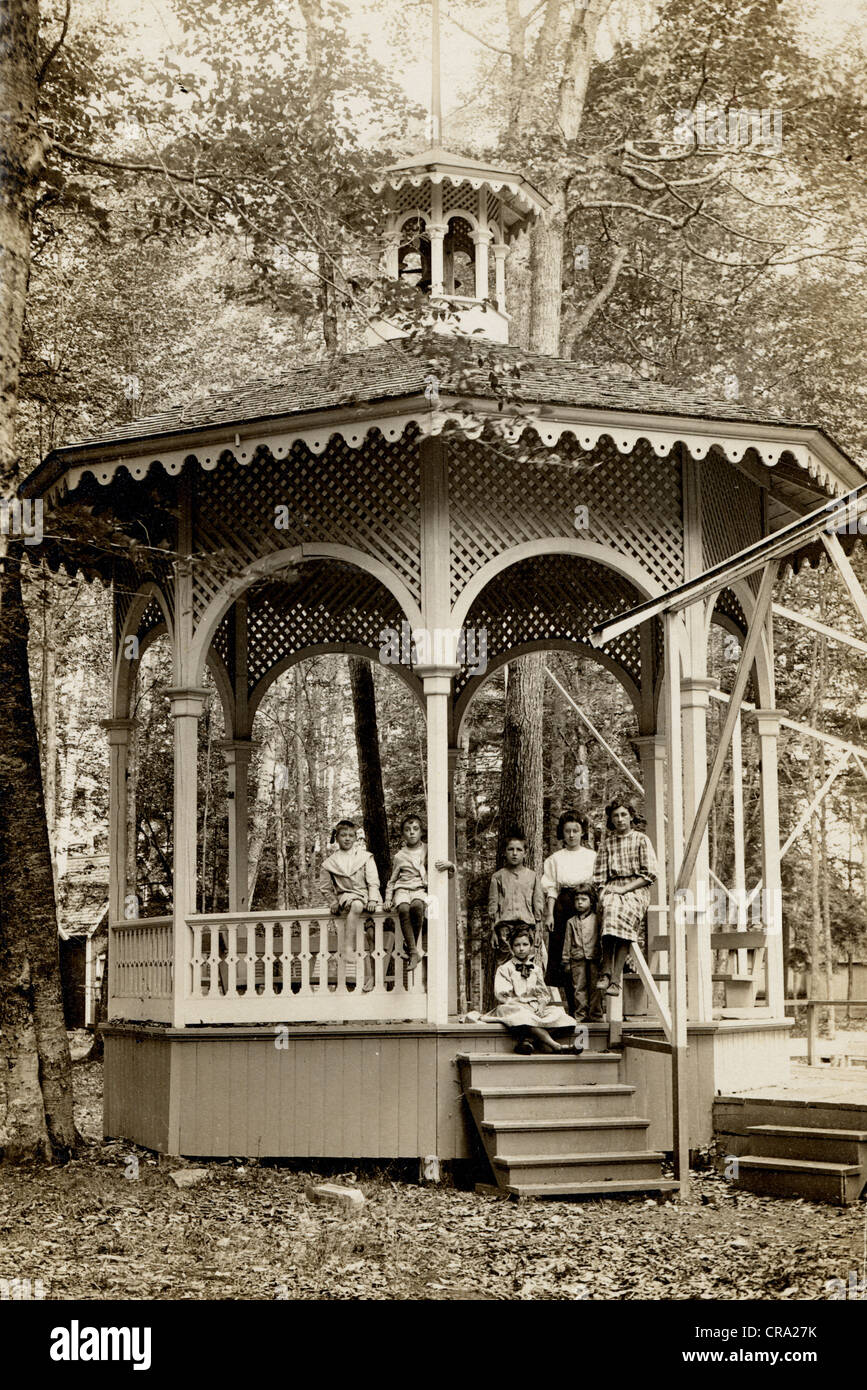 Group of Seven Children Perch on Victorian Bandstand Stock Photo
