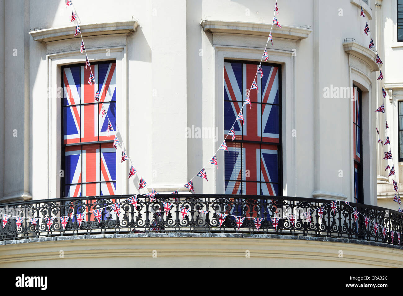 Union Jack blinds and bunting in window of a building. The Strand, London Stock Photo
