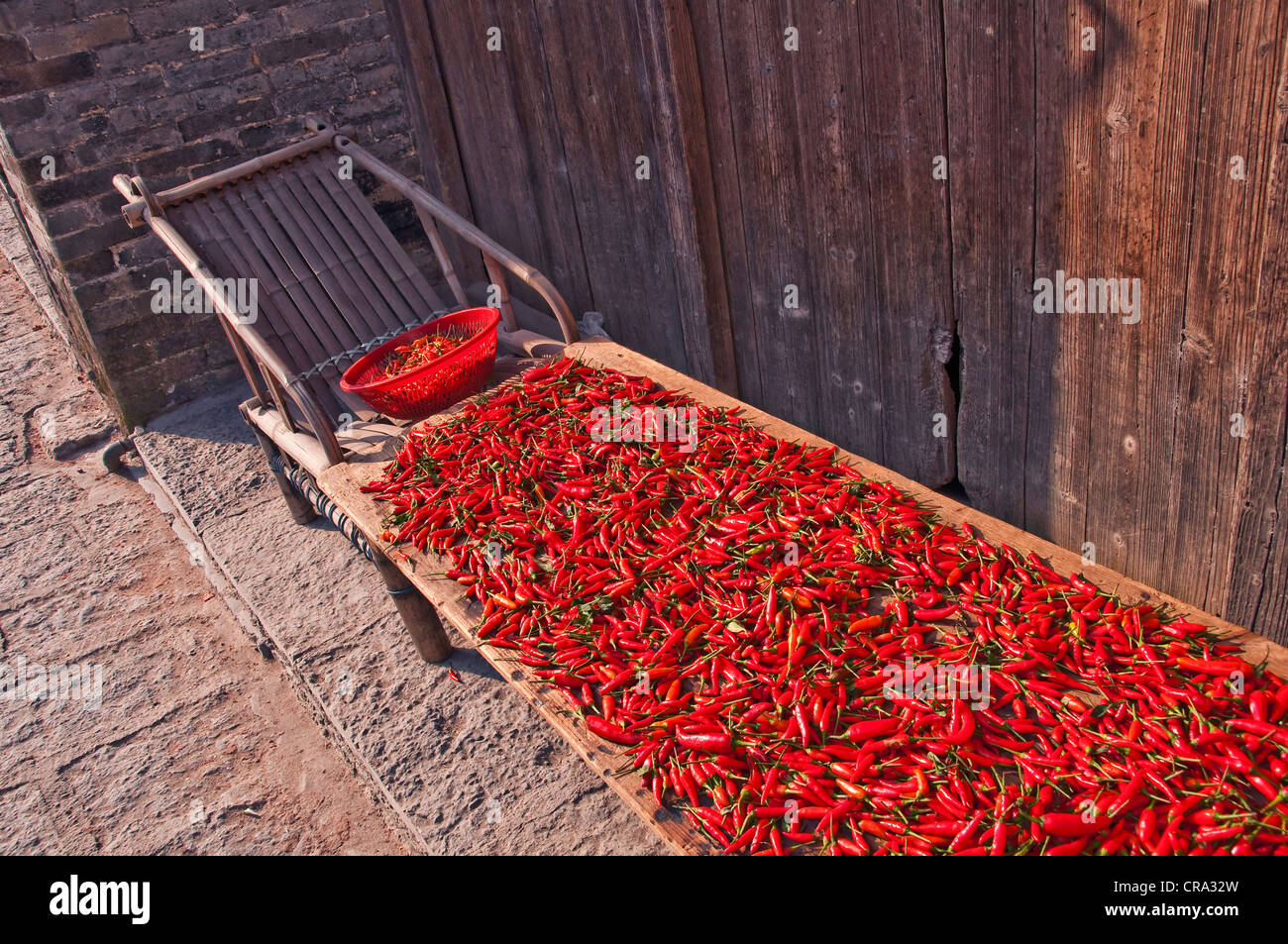 Red chilies drying in the sun - Dazhai village, Shanxi province, China Stock Photo