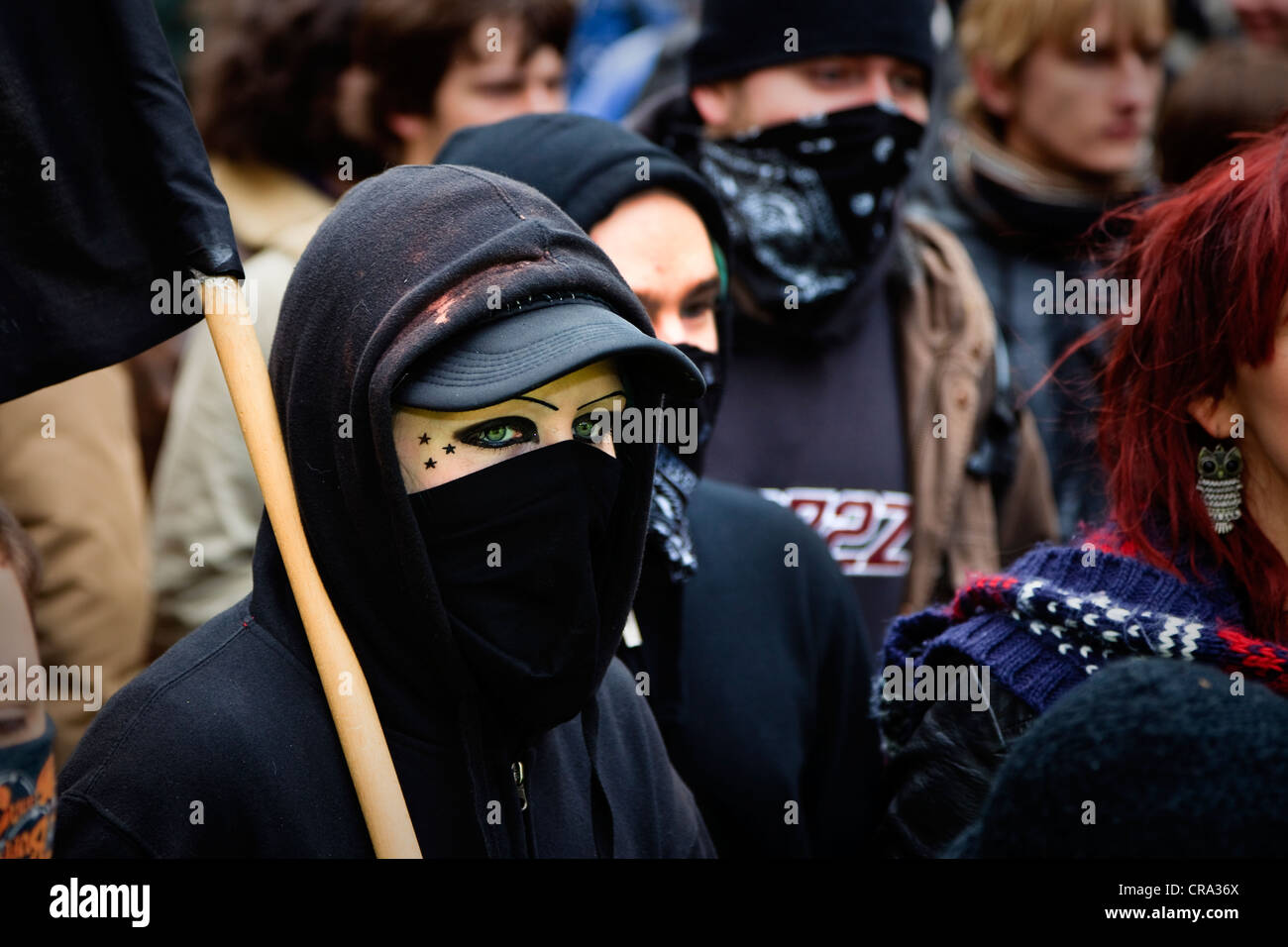 Demonstrator with a black flag and face covered up, at a street demonstration Glasgow, Scotland, UK Stock Photo