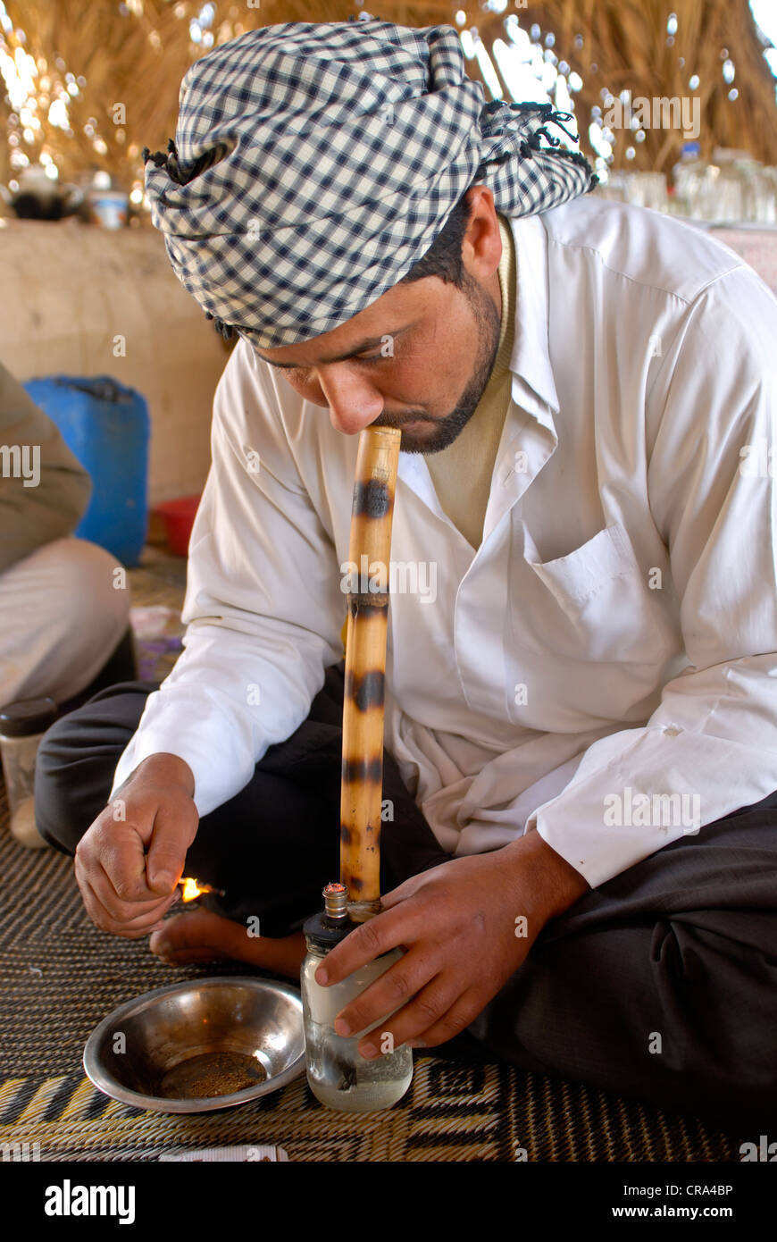 Bedouin preparing a marijuana pipe, Siwa oasis, Egypt, Africa Stock Photo