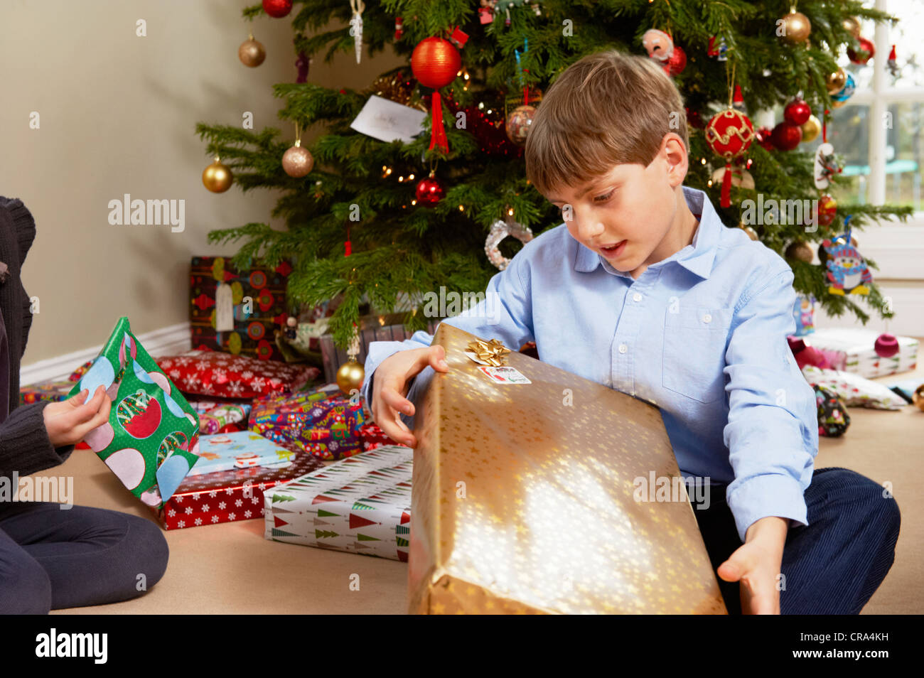 Children opening Christmas gifts Stock Photo
