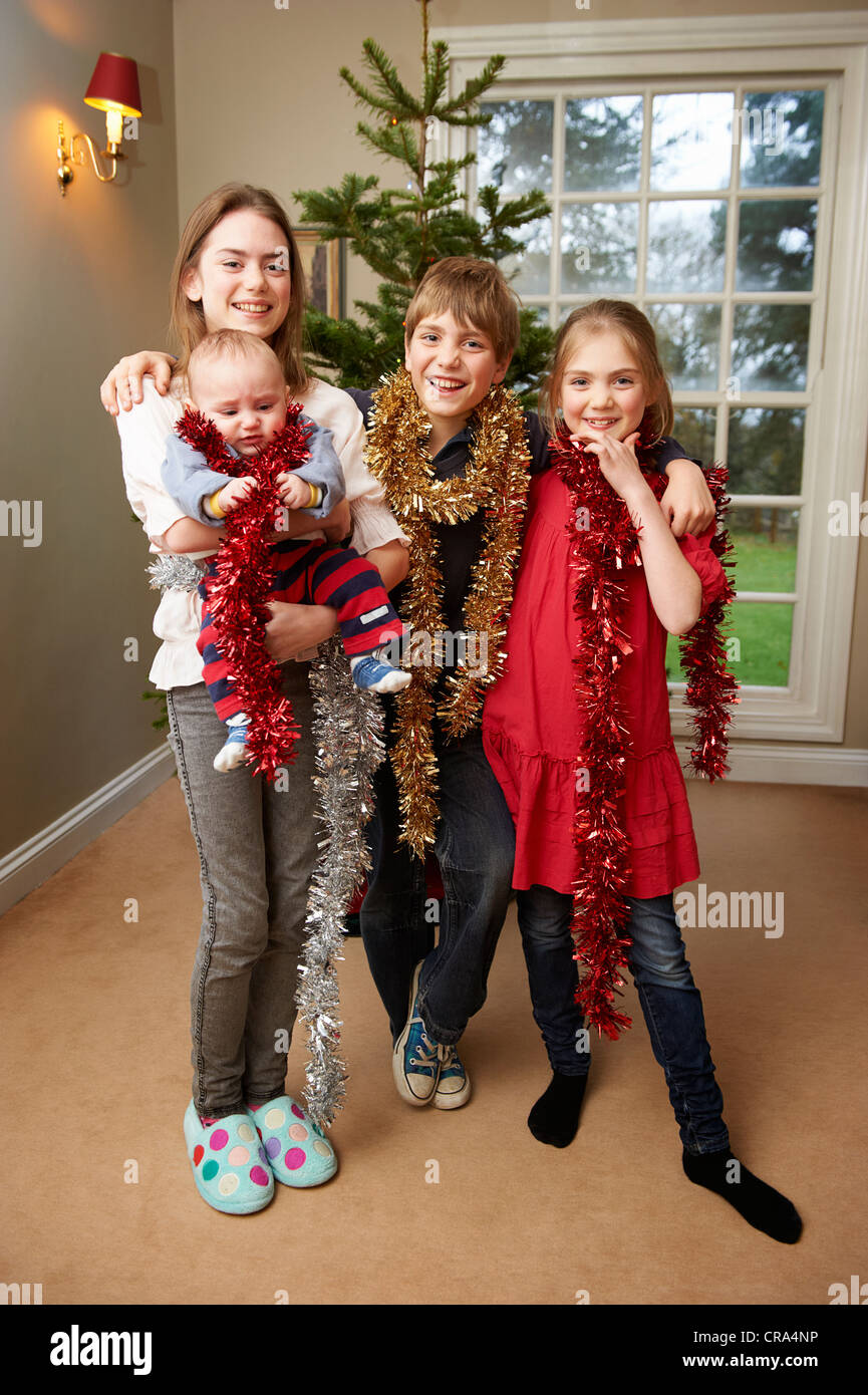 Children playing with Christmas tinsel Stock Photo