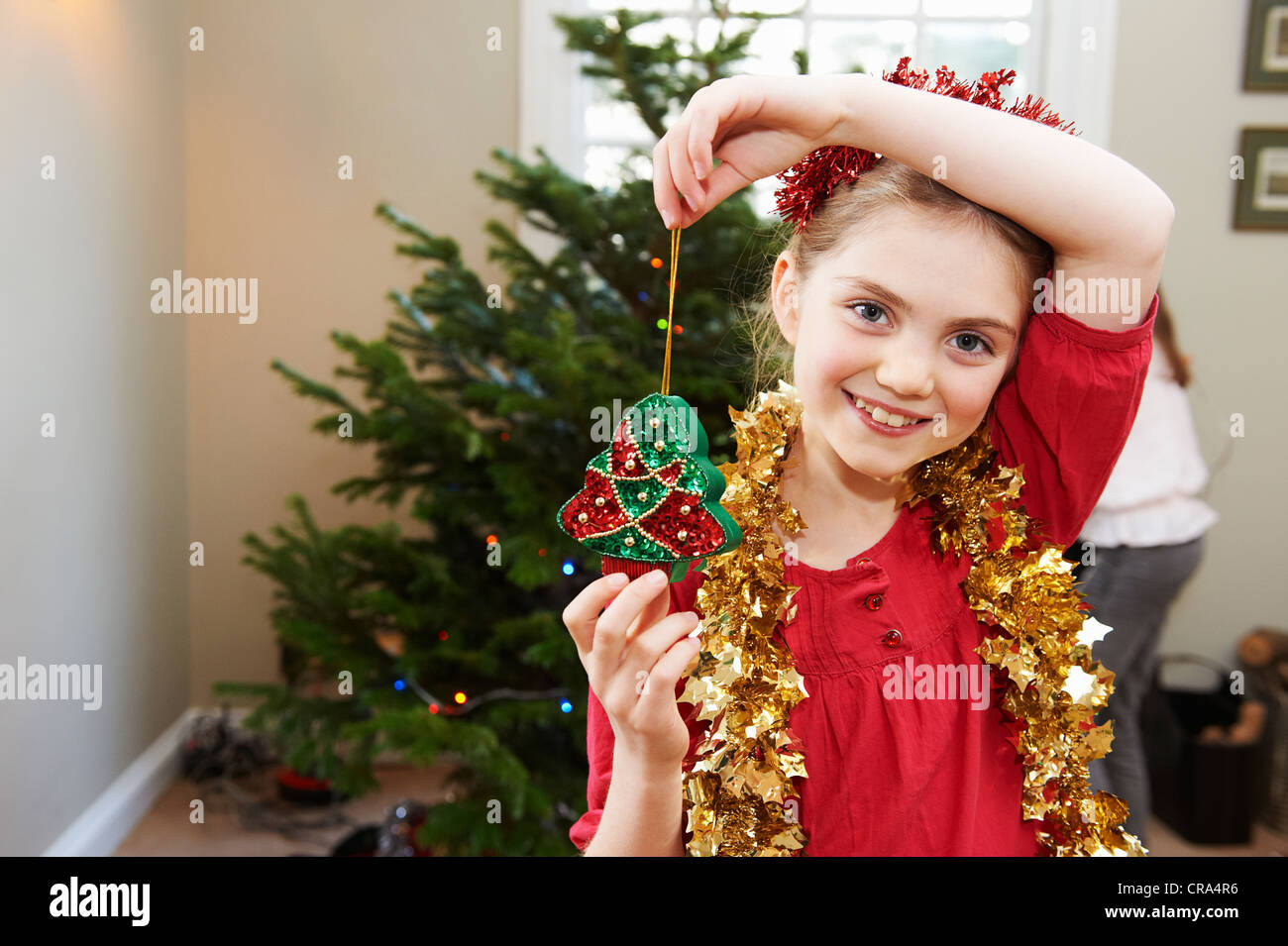 Girl playing with Christmas decorations Stock Photo