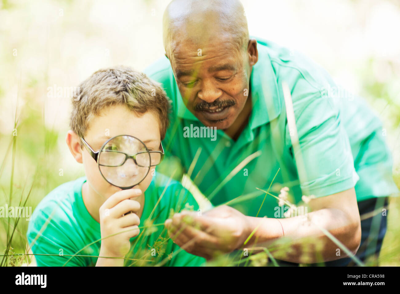Student examining plants with teacher Stock Photo