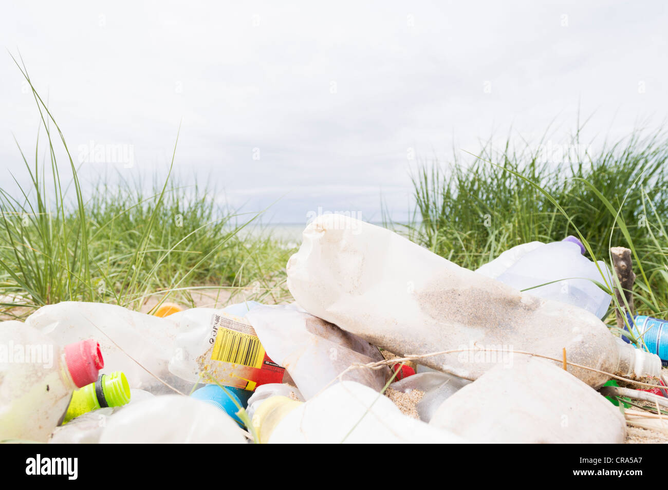 plastic bottles and other rubbish washed up by the tide on a beach Stock Photo