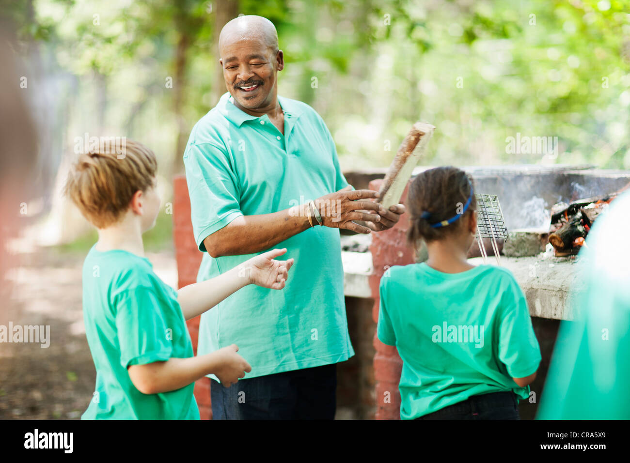 Students playing outside with teacher Stock Photo - Alamy