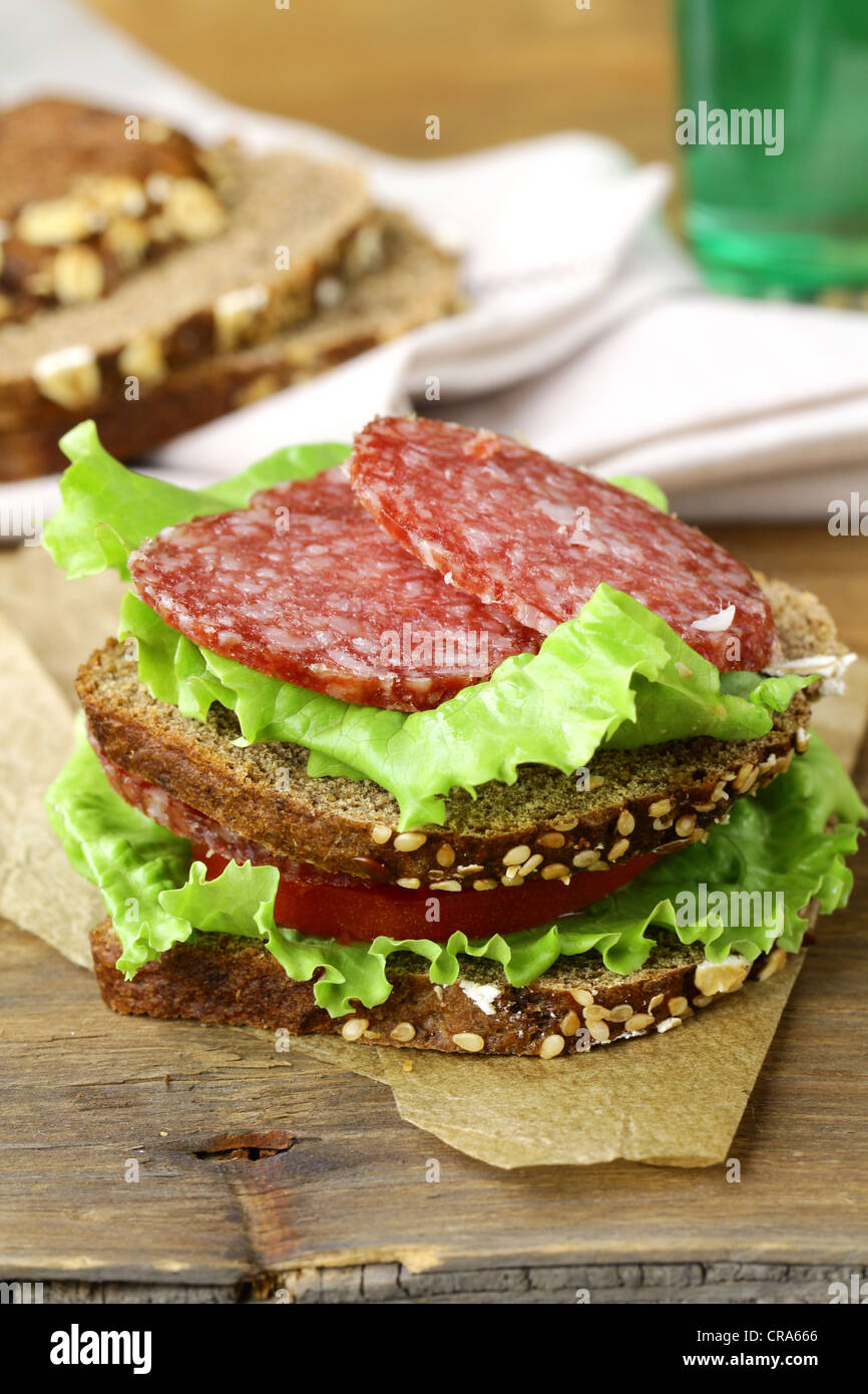 sandwich with sausage salami, lettuce and tomato Stock Photo Alamy