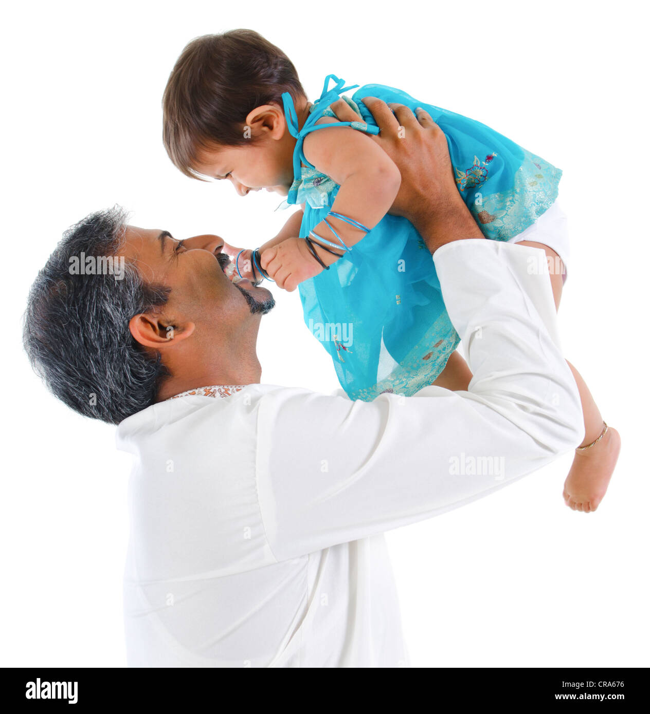 Mature traditional Indian father raise her baby girl up, isolated on