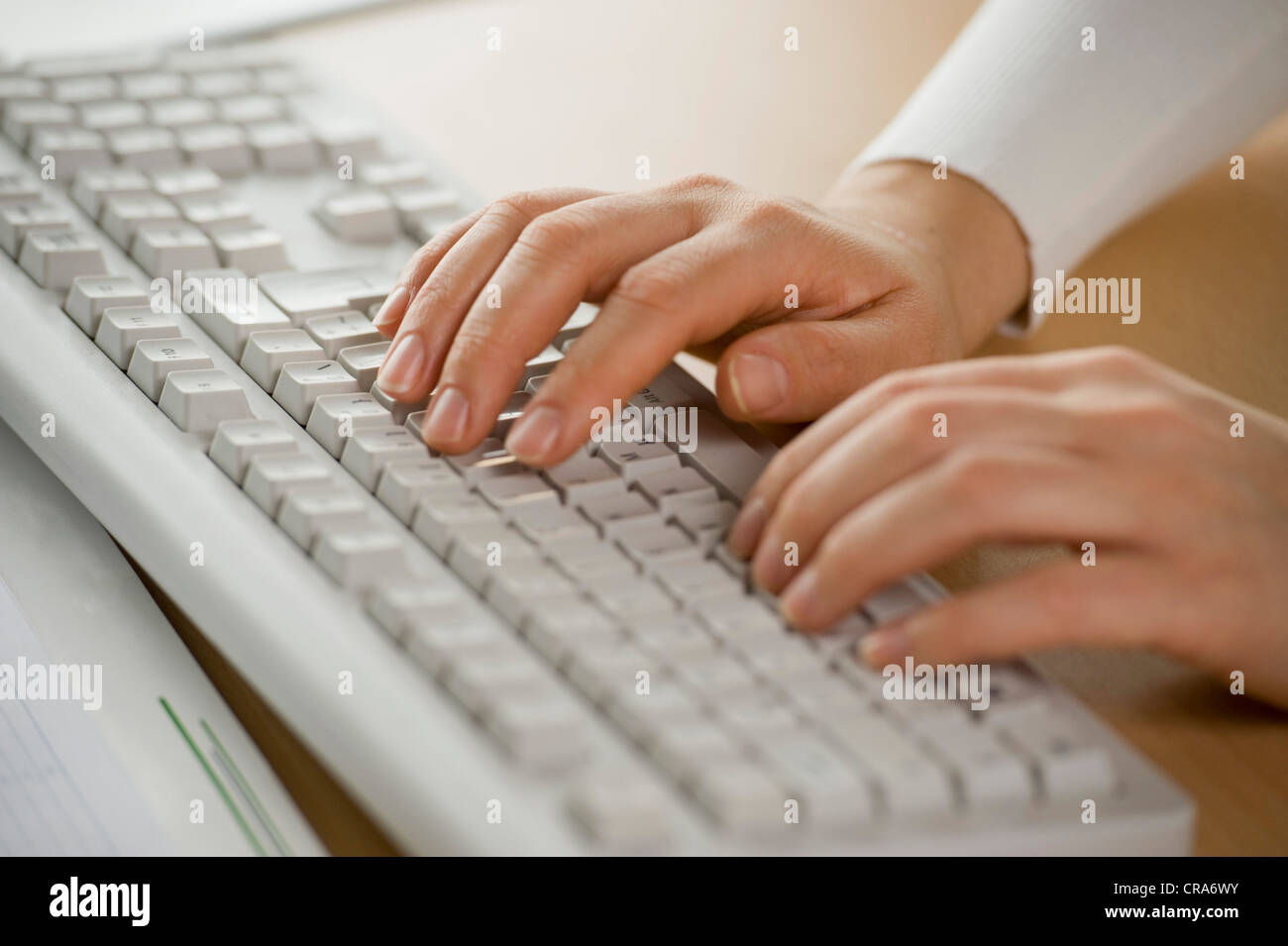Hands on a computer keyboard Stock Photo