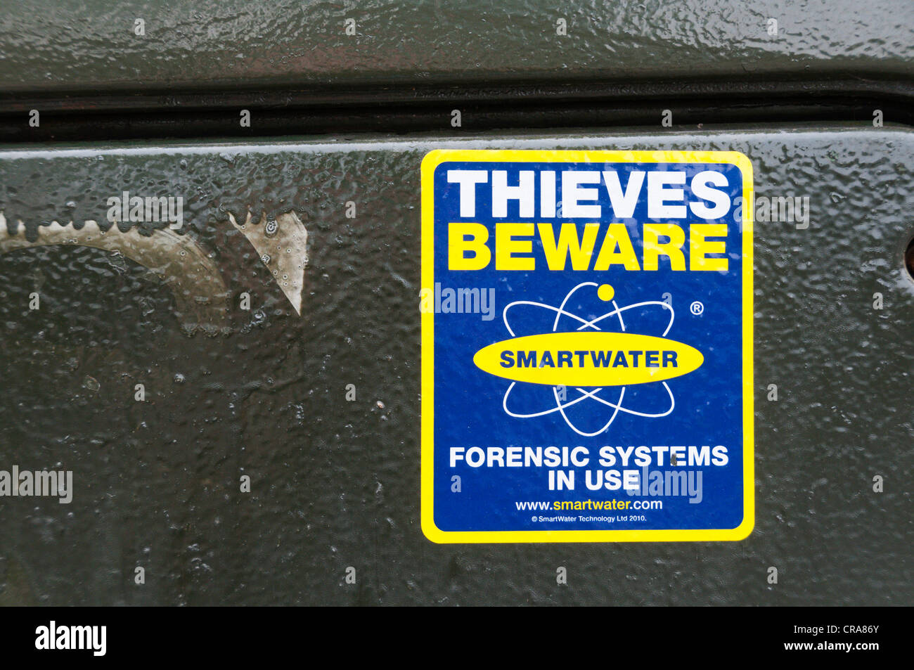 Thieves Beware Smartwater Forensic Systems In Use warning sticker on a telephone street cabinet. Stock Photo