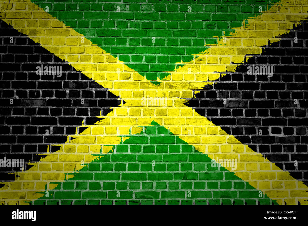 An image of the Jamaica flag painted on a brick wall in an urban location Stock Photo