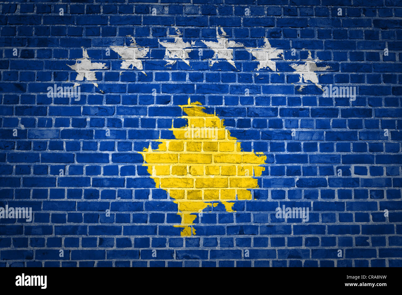 An image of the Kosovo flag painted on a brick wall in an urban location Stock Photo