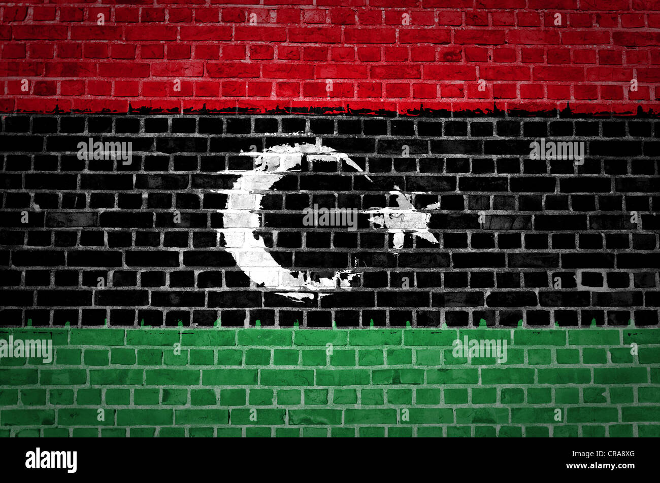 An image of the Libya flag painted on a brick wall in an urban location Stock Photo