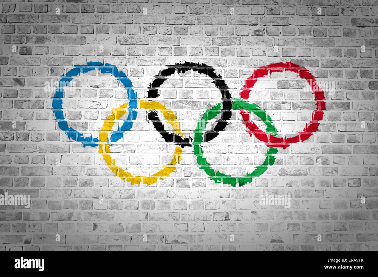 An image of the Olympic Movement flag painted on a brick wall in an urban location Stock Photo