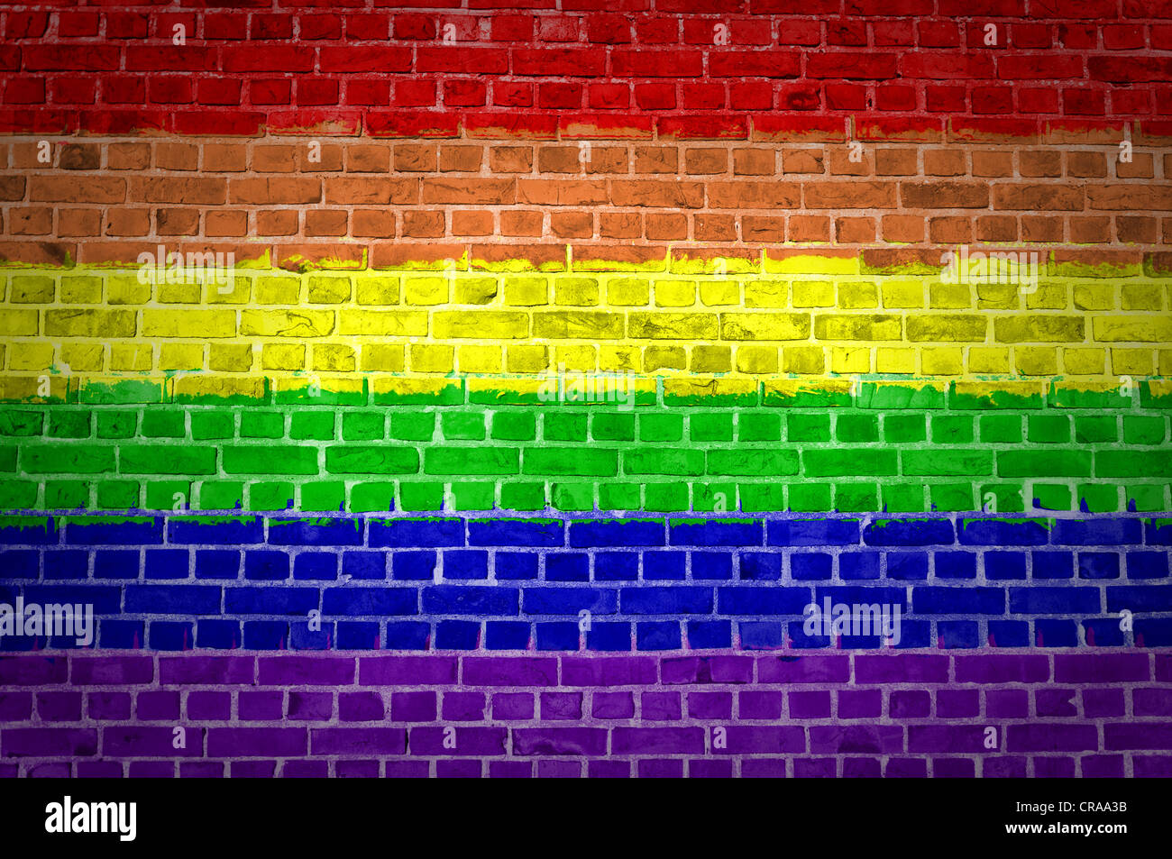 An image of the Rainbow flag painted on a brick wall in an urban ...