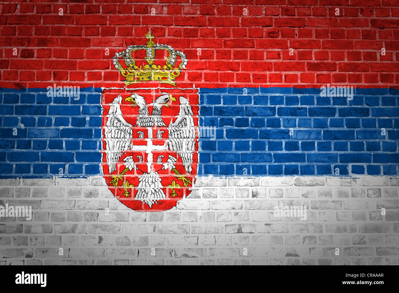 An image of the Serbia flag painted on a brick wall in an urban location Stock Photo