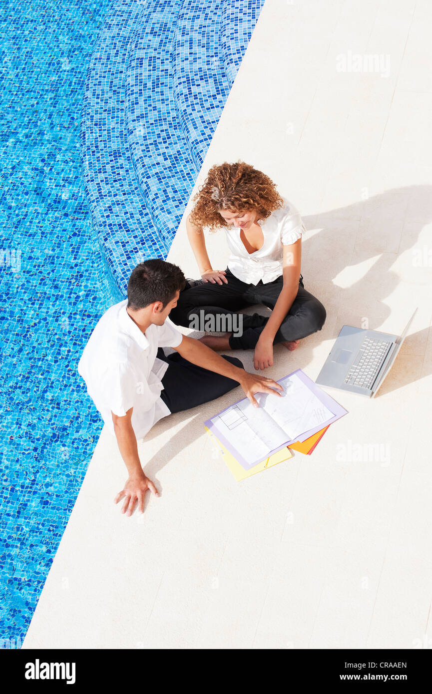 Business people working together by pool Stock Photo Alamy