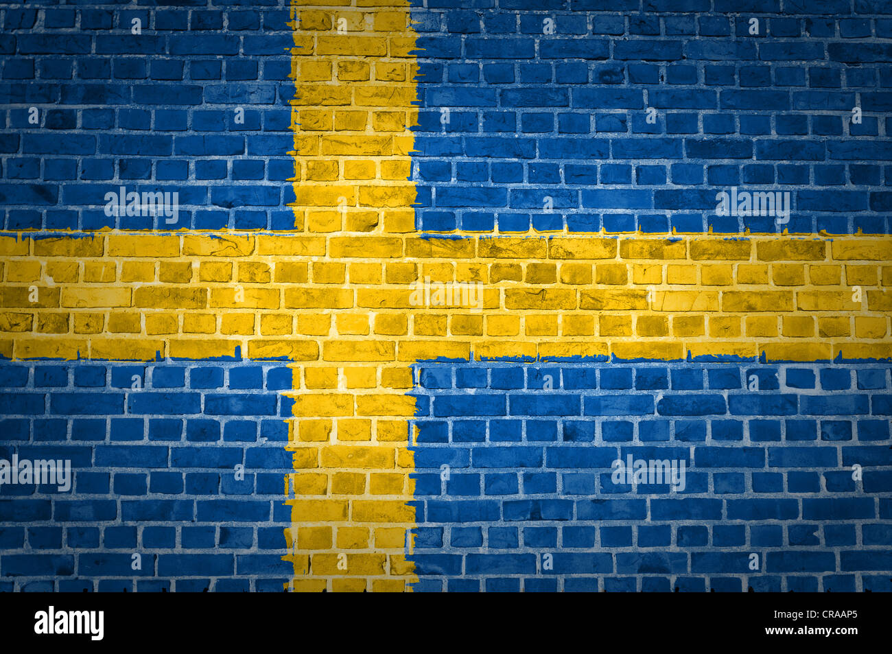 An image of the Sweden flag painted on a brick wall in an urban location Stock Photo