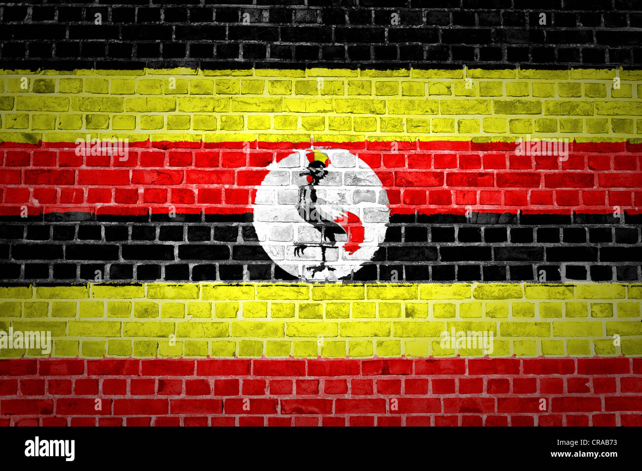An image of the Uganda flag painted on a brick wall in an urban