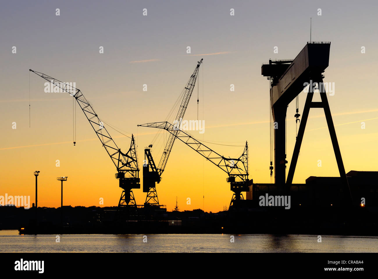 Cranes of the HDW shipyard, Howaldtswerke-Deutsche Werft GmbH, in cooperation with Thyssen-Krupp Marine Systems AG, morning mood Stock Photo