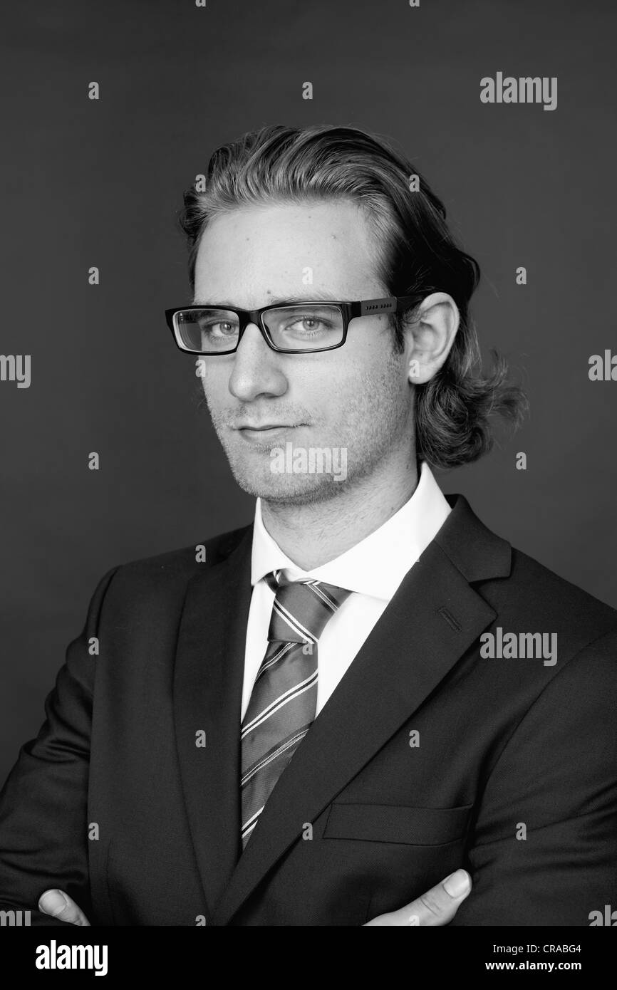 Young man wearing a business suit and glasses, portrait Stock Photo - Alamy