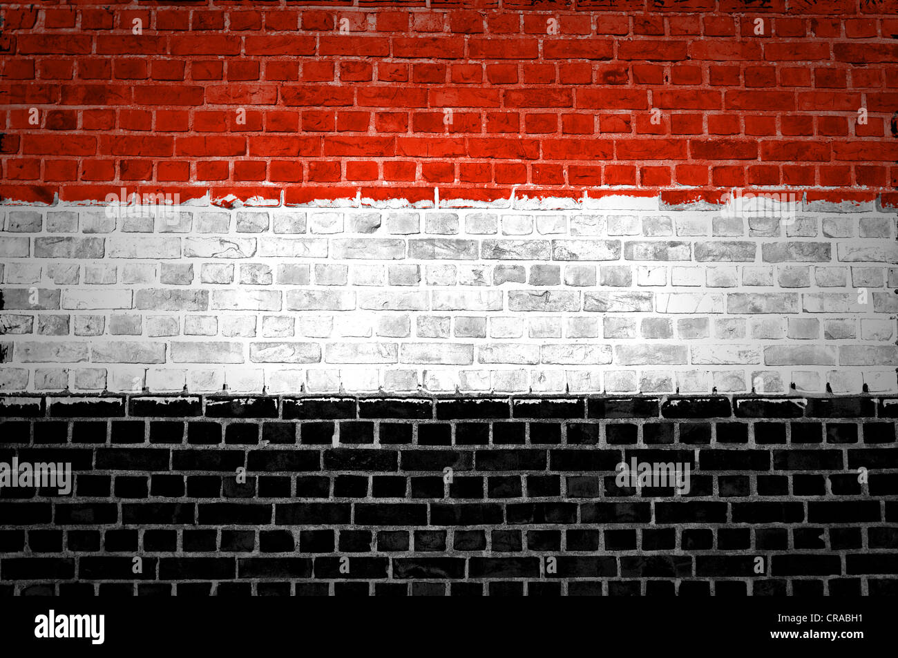 An image of the Yemen flag painted on a brick wall in an urban location ...