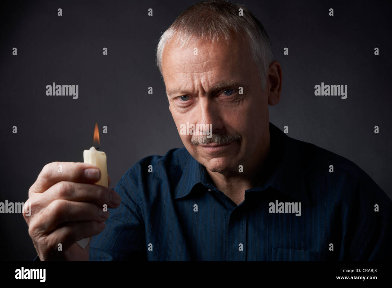 Man with burning candle Stock Photo Alamy