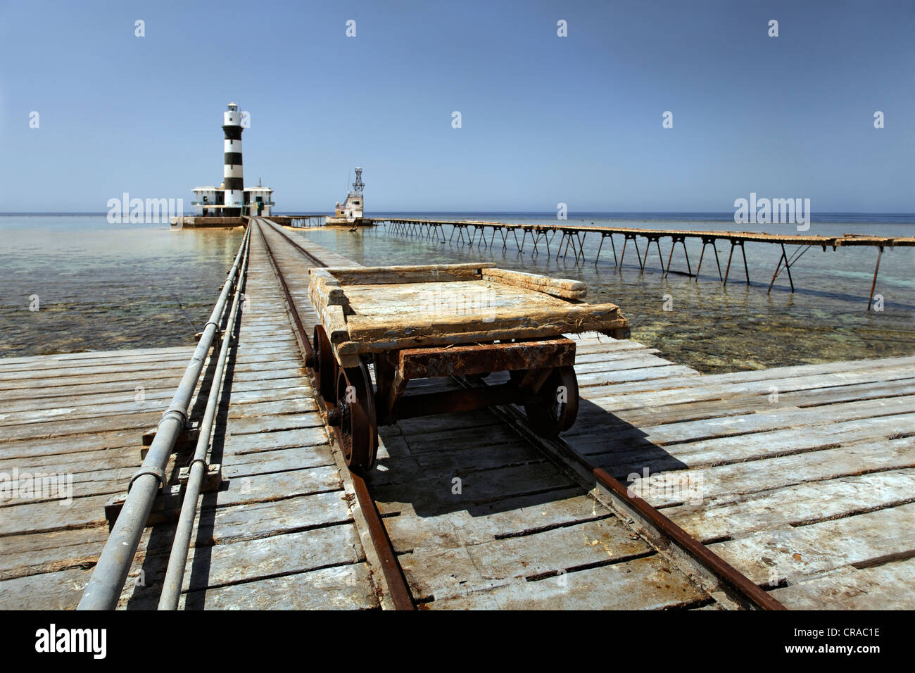 Trolley, rail car and rails, lighthouse with adjoining building, jetty and reef top, Daedalus Reef, Egypt, Red Sea, Africa Stock Photo