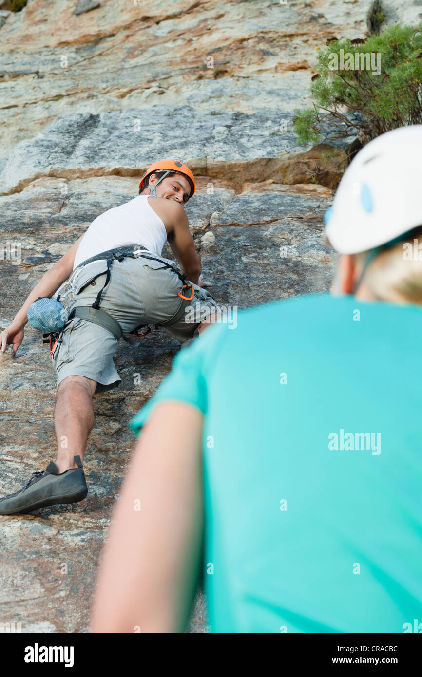 Climbers scaling steep rock face Stock Photo Alamy