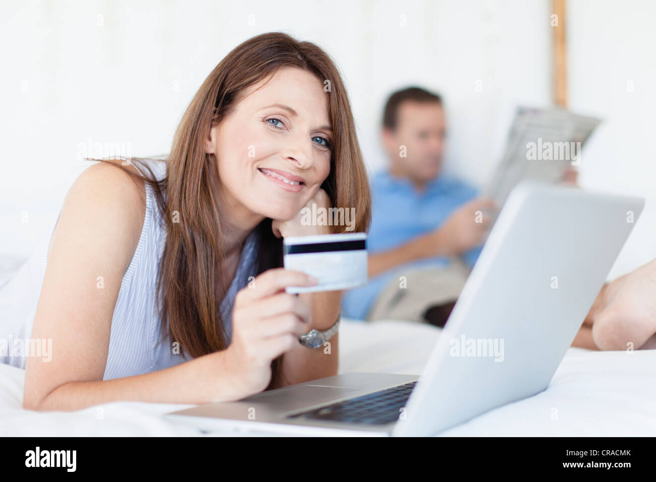 Woman shopping online on bed Stock Photo Alamy