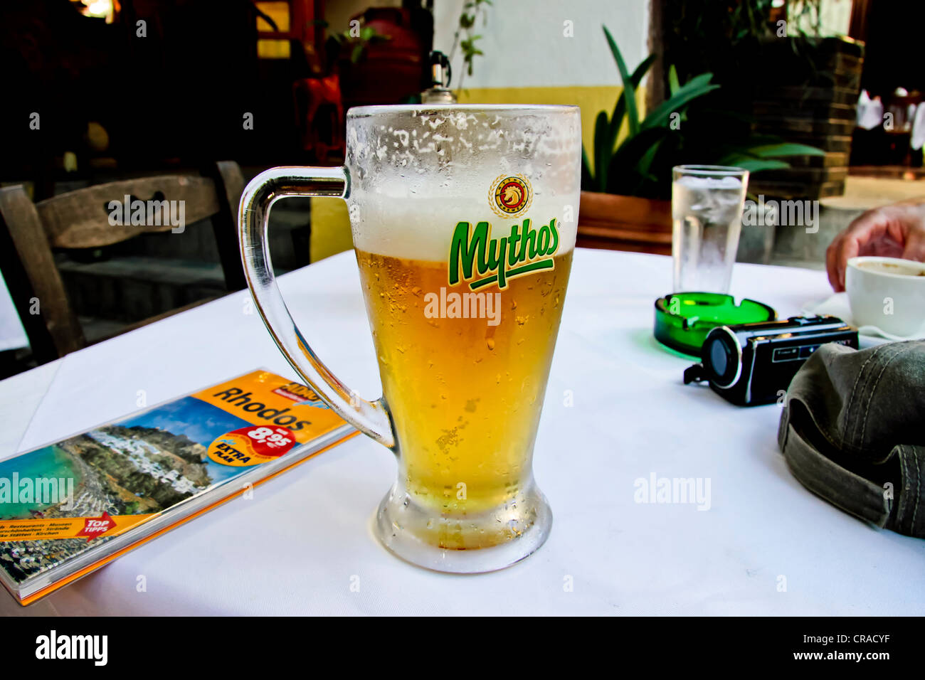 Beer glass, guidebook, tavern, historic centre of Rhodes, Greece ...