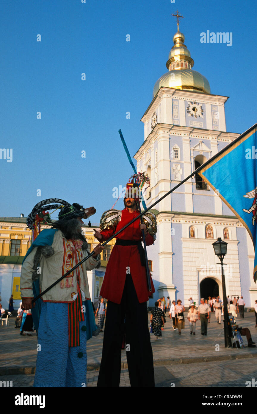 Two men dressed in traditional costume stand at the entrance of Saint