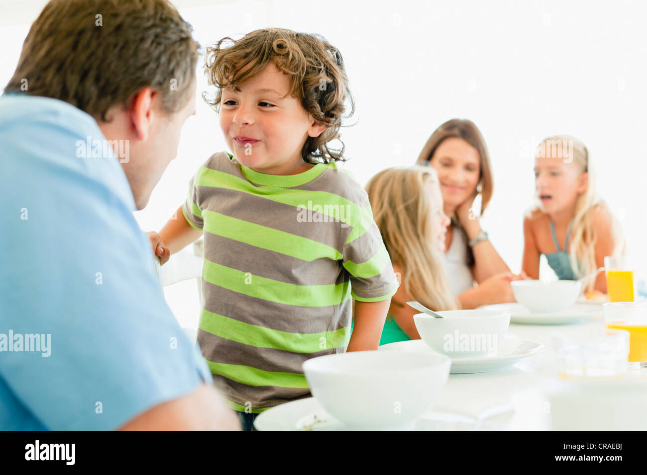 Family talking at breakfast table Stock Photo
