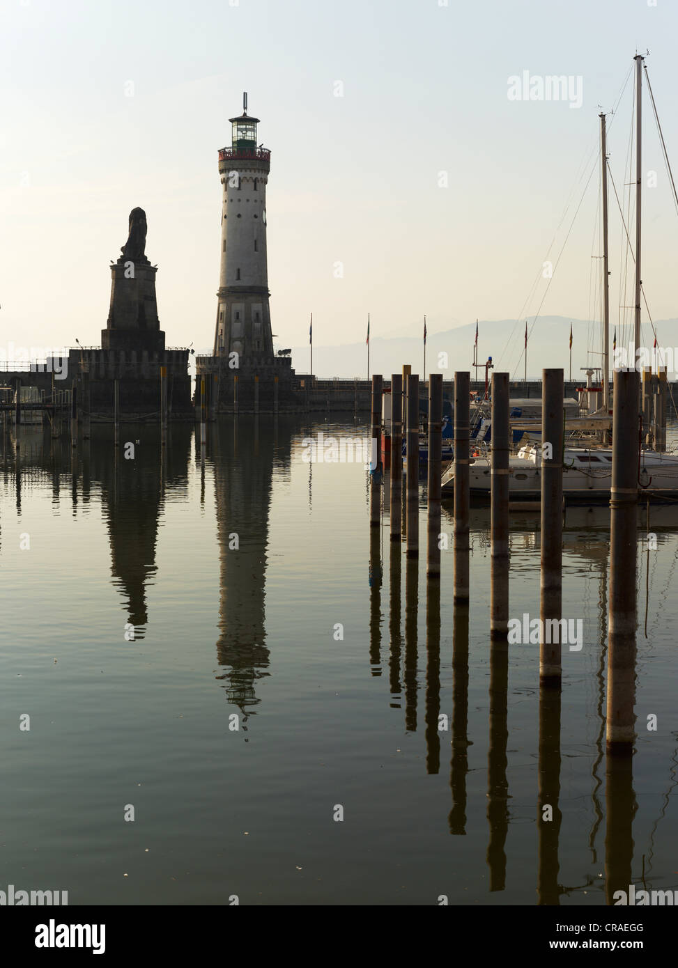 Harbour entrance of Lindau, back lit, with the Bavarian lion and the lighthouse of Lindau, Lake Constance, Swabia, Bavaria Stock Photo