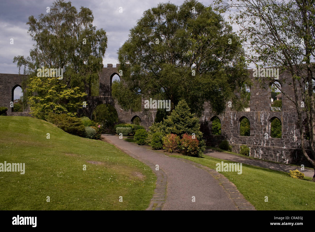 A path leading through the gardens inside McCaig's Tower on Battery Hill in Oban, Scotland. Stock Photo