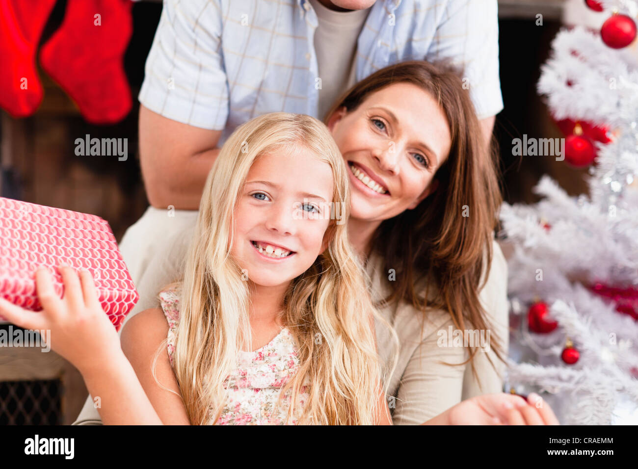 Family smiling with Christmas gifts Stock Photo