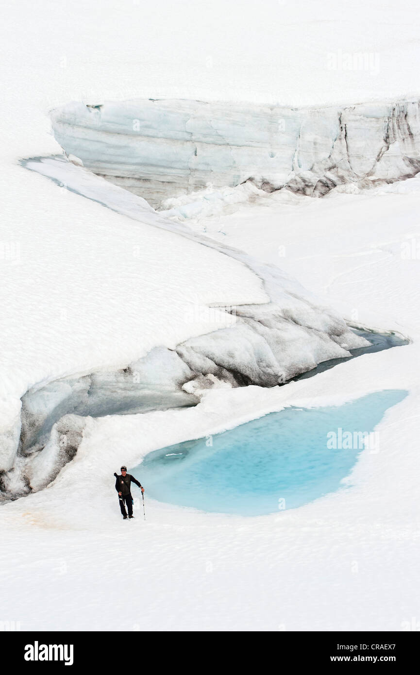 Leader of a group of hikers with a rifle, at Mittivakkat Glacier, Ammassalik Peninsula, East Greenland, Greenland Stock Photo