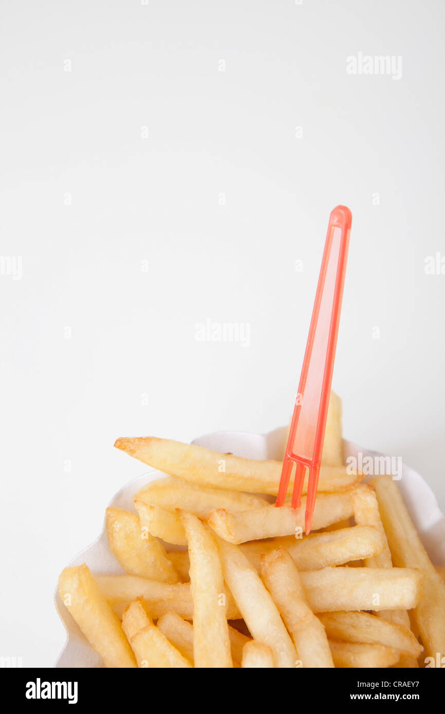 French fries on a paper plate with a snack fork Stock Photo Alamy