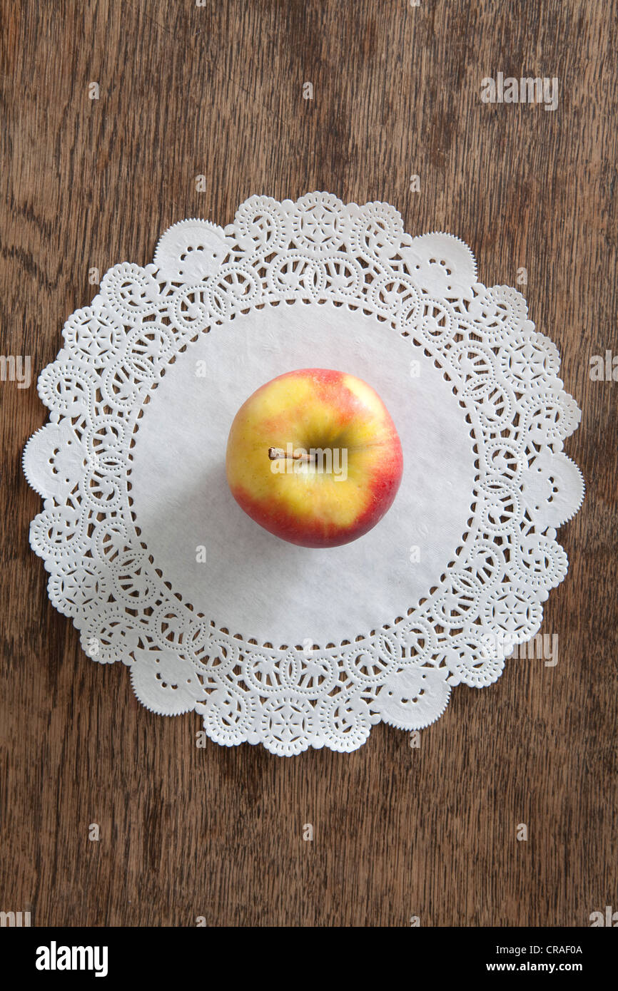 Apple on a paper doily, diet Stock Photo