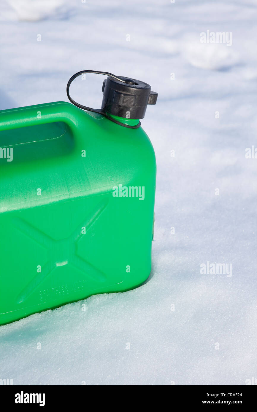 Green petrol canister in the snow, winter, energy consumption Stock Photo